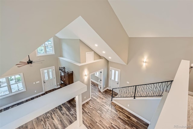 interior space featuring high vaulted ceiling, wood-type flooring, and ceiling fan