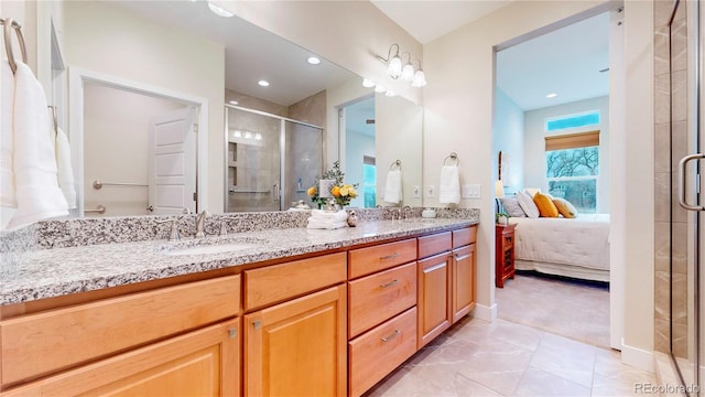 full bath featuring double vanity, a stall shower, ensuite bath, and a sink