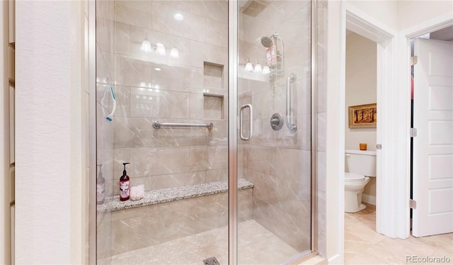 full bathroom with a shower stall and toilet