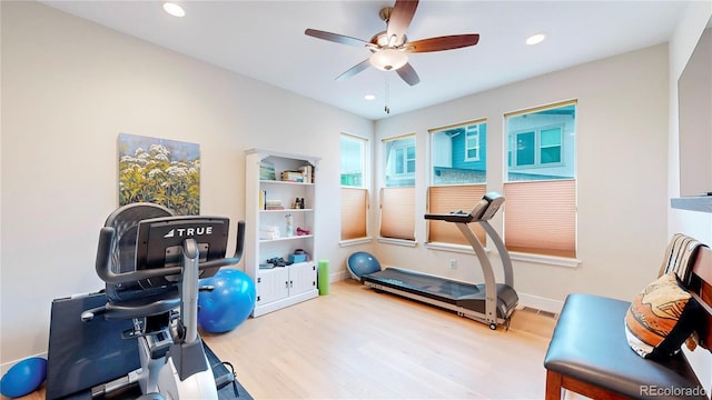 workout area with recessed lighting and wood finished floors