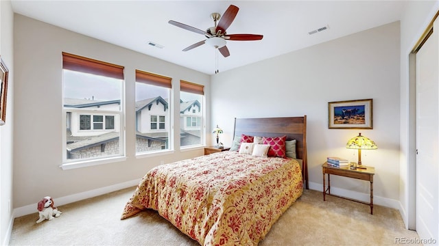 bedroom with light colored carpet, visible vents, and baseboards