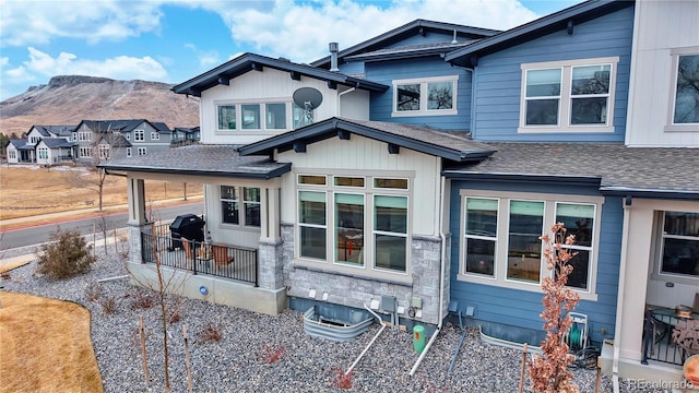 view of front of home with a mountain view and a shingled roof