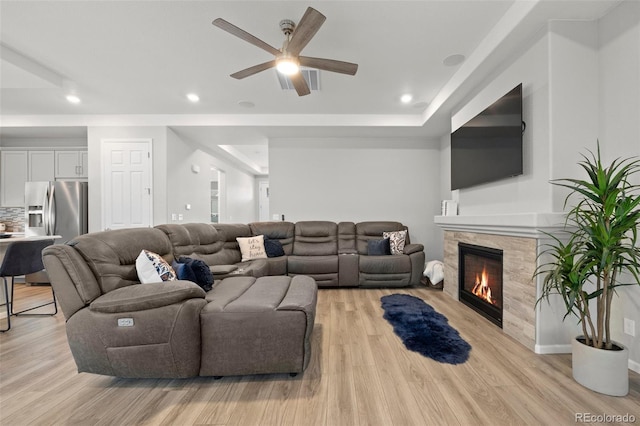 5108 N Quatar St, Aurora, CO 80019 - living area with recessed lighting, a ceiling fan, a glass covered fireplace, and light wood-style floors