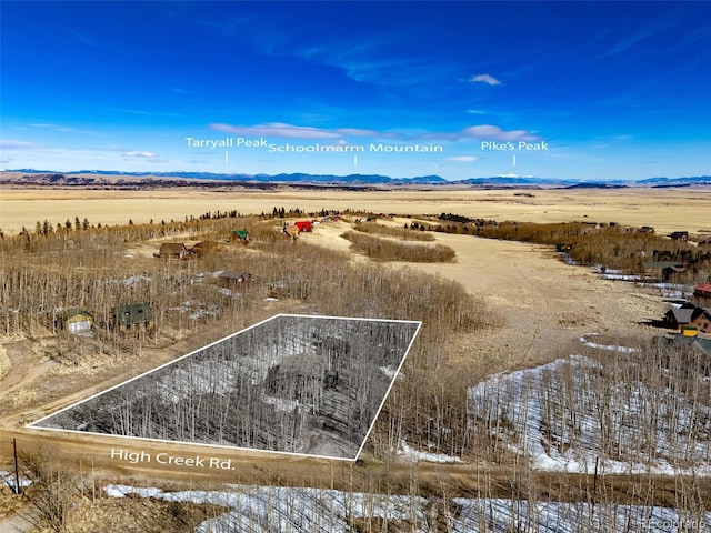 drone / aerial view featuring a rural view and a mountain view