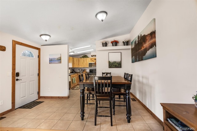 dining space with light tile patterned floors, visible vents, and baseboards