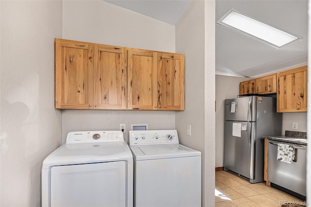 laundry area featuring washing machine and dryer, laundry area, and light tile patterned flooring