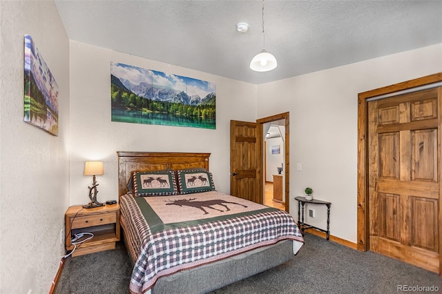 bedroom featuring carpet, a textured ceiling, and baseboards