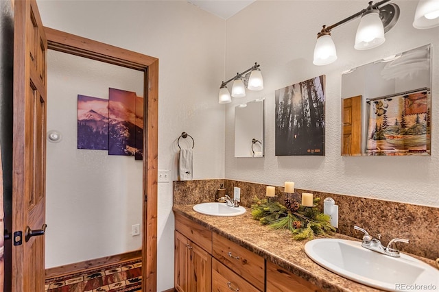 full bathroom featuring double vanity and a sink