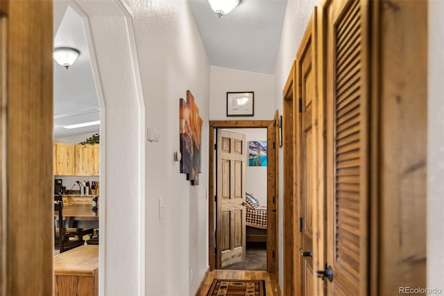 hallway with a textured ceiling