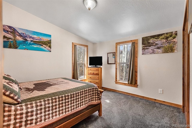 carpeted bedroom with vaulted ceiling, a textured wall, a textured ceiling, and baseboards