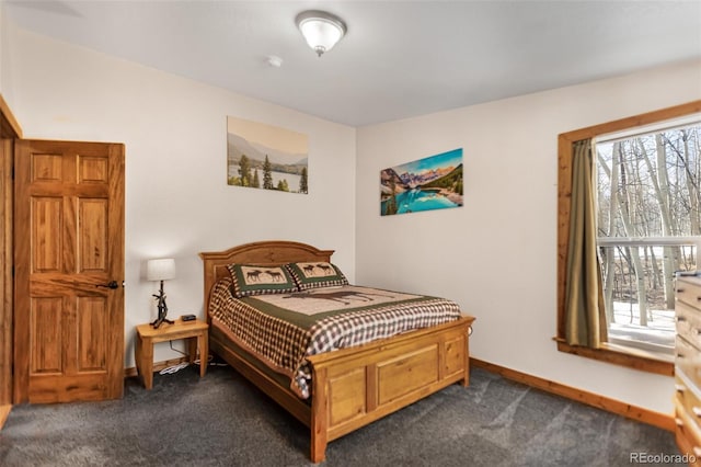 bedroom featuring baseboards and dark colored carpet