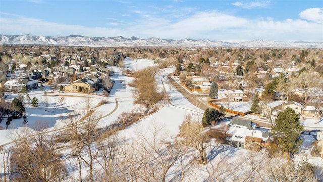 snowy aerial view with a residential view and a mountain view