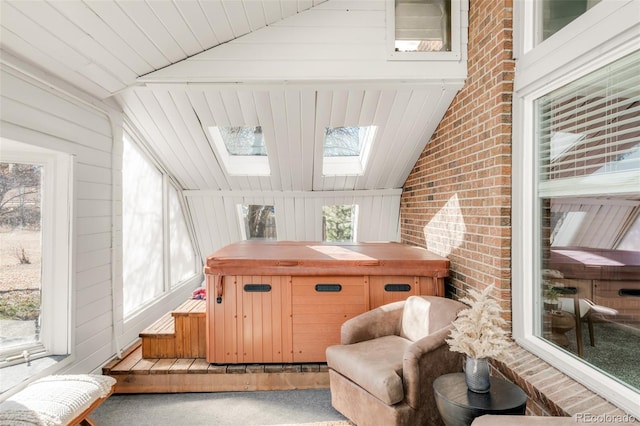 sunroom with lofted ceiling with skylight