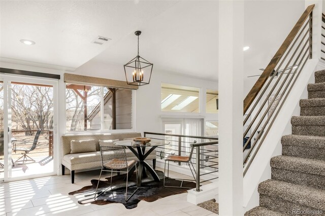 interior space featuring a chandelier, visible vents, and stairs