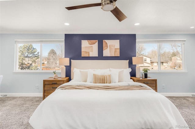 carpeted bedroom with ceiling fan, baseboards, crown molding, and recessed lighting