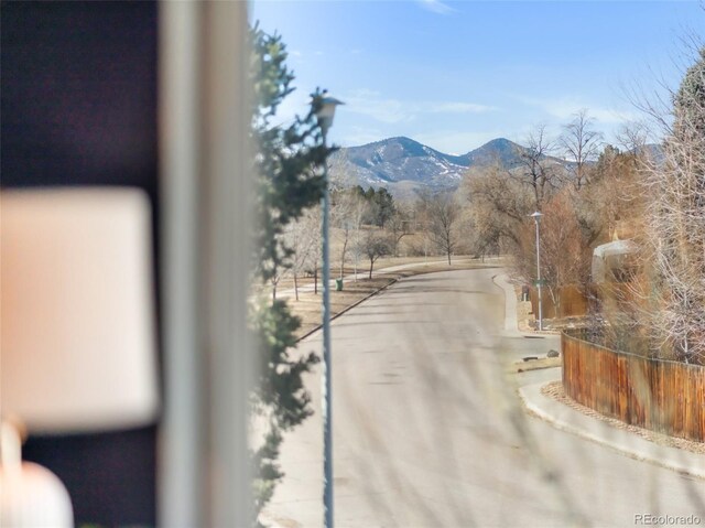 view of road with street lights and a mountain view