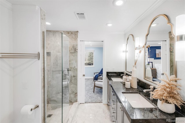 full bath featuring a sink, visible vents, a shower stall, double vanity, and crown molding