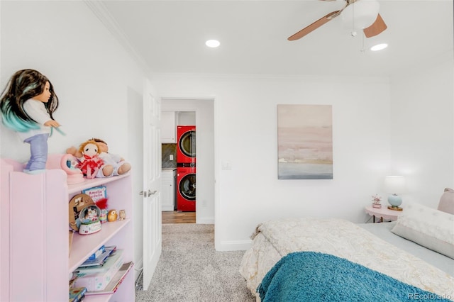 carpeted bedroom featuring baseboards, a ceiling fan, stacked washer and clothes dryer, and crown molding