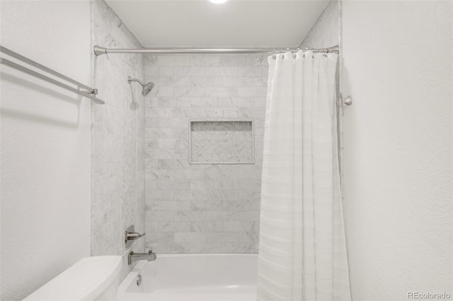 bathroom featuring shower / bath combination with curtain and toilet