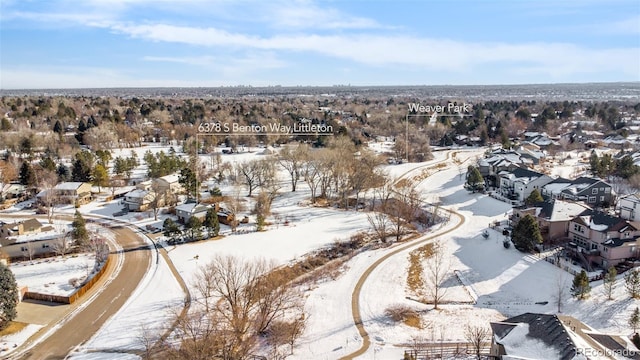 snowy aerial view with a residential view