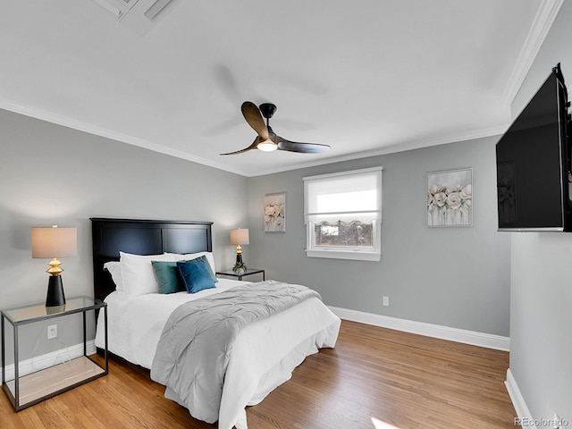 bedroom featuring crown molding, hardwood / wood-style floors, and ceiling fan