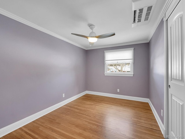 spare room featuring light hardwood / wood-style floors, ornamental molding, and ceiling fan