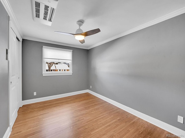 spare room featuring ceiling fan, ornamental molding, and light hardwood / wood-style floors