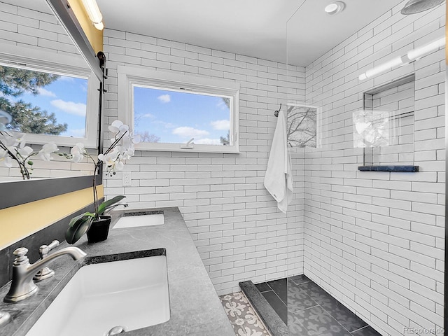 bathroom featuring tiled shower, tile patterned floors, and vanity