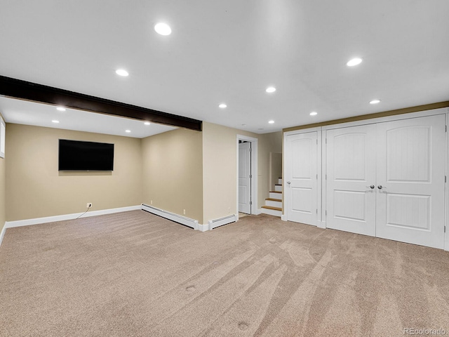 basement featuring baseboard heating and carpet flooring