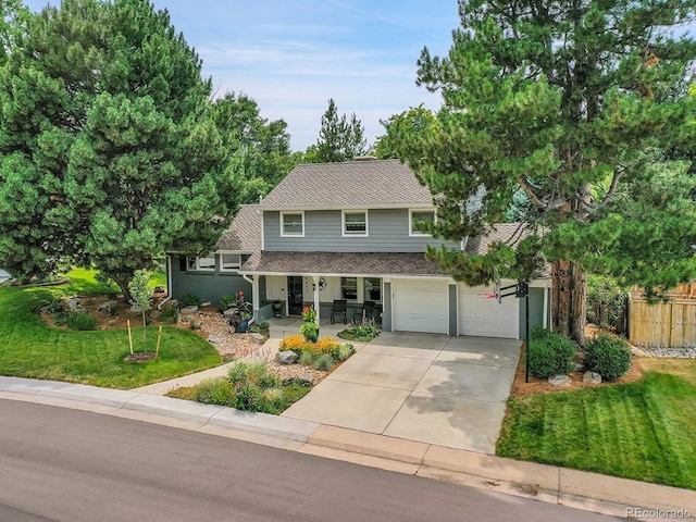 view of front of house with a front yard and a garage