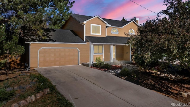 308 Oswego St, Aurora, CO 80010 - view of front of house featuring covered porch, an attached garage, driveway, and a chimney