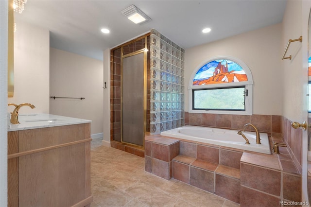 308 Oswego St, Aurora, CO 80010 - full bath with a garden tub, a shower stall, double vanity, and recessed lighting