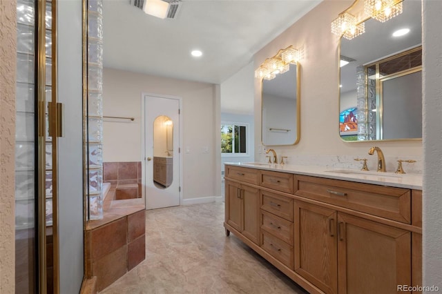 308 Oswego St, Aurora, CO 80010 - full bath featuring double vanity, a bath, a chandelier, recessed lighting, and tile patterned floors