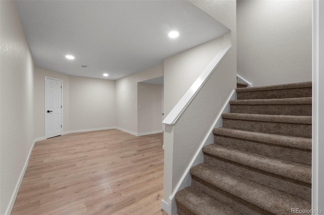 308 Oswego St, Aurora, CO 80010 - stairs featuring wood finished floors, recessed lighting, and baseboards
