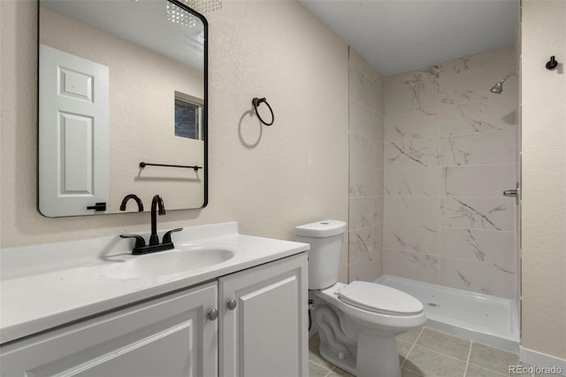 308 Oswego St, Aurora, CO 80010 - bathroom with vanity, tiled shower, toilet, and tile patterned floors