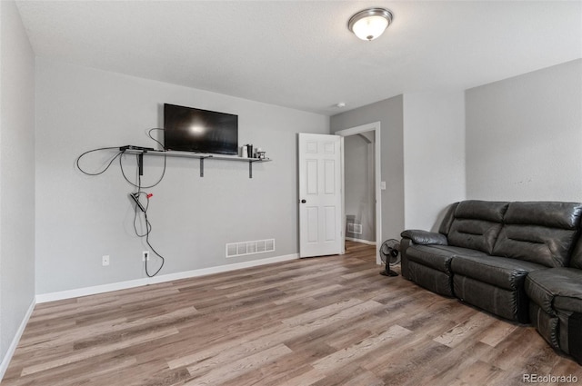 living room featuring light wood-type flooring and baseboards