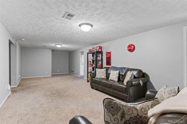 living room featuring baseboards, carpet, and a textured ceiling