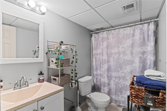full bathroom featuring a paneled ceiling, toilet, vanity, a shower with shower curtain, and tile patterned floors