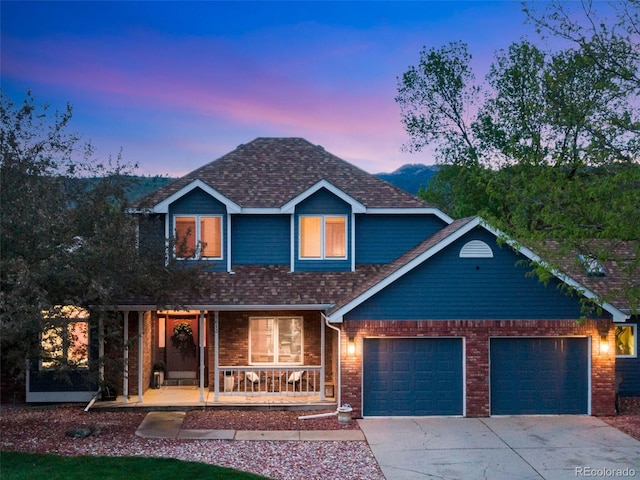 2613 Fox Run Ct, Fort Collins, CO 80526 - traditional-style house with covered porch, an attached garage, concrete driveway, brick siding, and roof with shingles