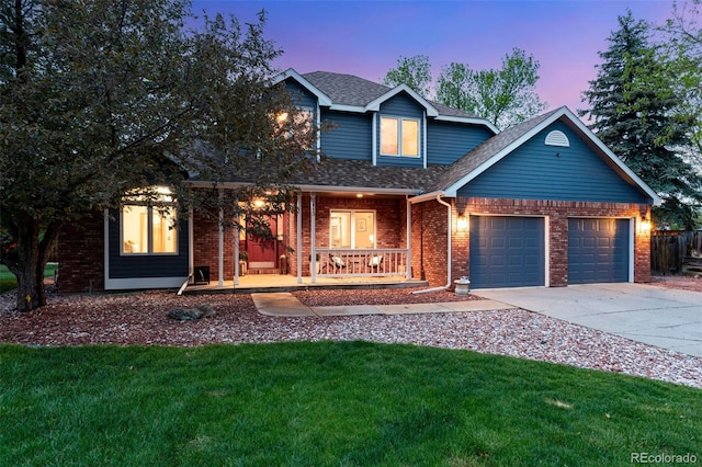 2613 Fox Run Ct, Fort Collins, CO 80526 - traditional-style house with covered porch, brick siding, an attached garage, concrete driveway, and a lawn