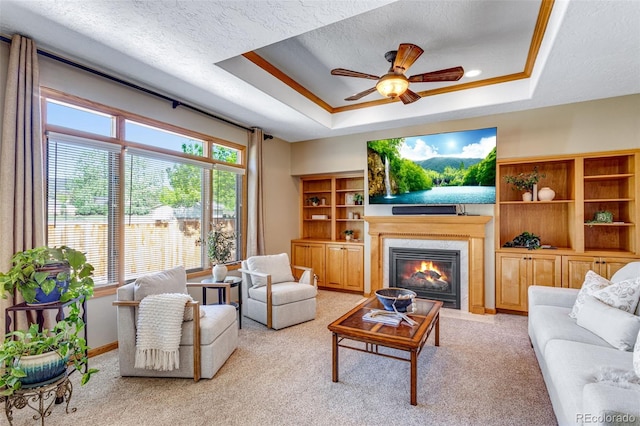 2613 Fox Run Ct, Fort Collins, CO 80526 - living room with a tray ceiling, a ceiling fan, light carpet, a premium fireplace, and a textured ceiling
