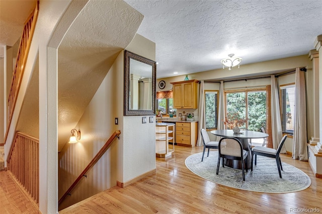 2613 Fox Run Ct, Fort Collins, CO 80526 - dining room with a textured ceiling, light wood-type flooring, and baseboards