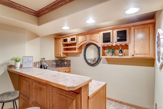2613 Fox Run Ct, Fort Collins, CO 80526 - kitchen with a peninsula, glass insert cabinets, open shelves, a kitchen breakfast bar, and recessed lighting