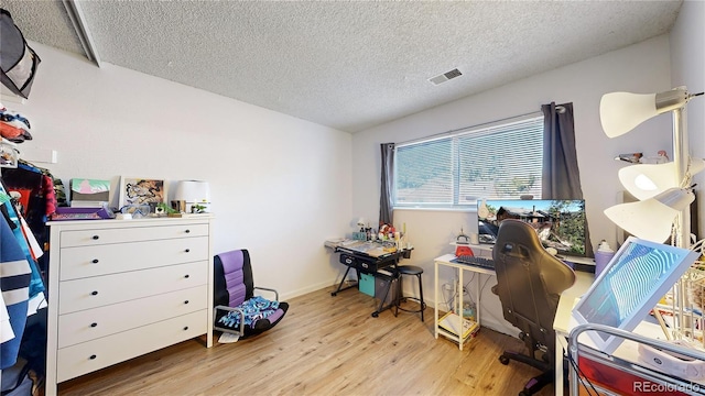 office space featuring light hardwood / wood-style flooring and a textured ceiling