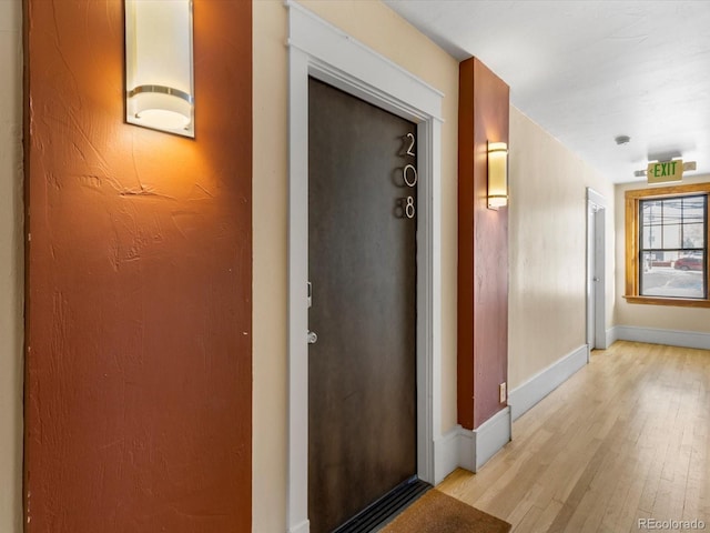 corridor with light hardwood / wood-style floors