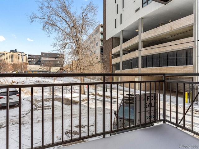 view of snow covered back of property