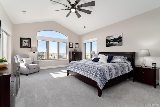 bedroom with light carpet, vaulted ceiling, baseboards, and a ceiling fan