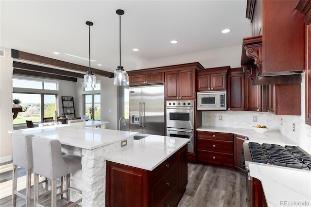 kitchen with built in appliances, tasteful backsplash, wood finished floors, a large island, and recessed lighting