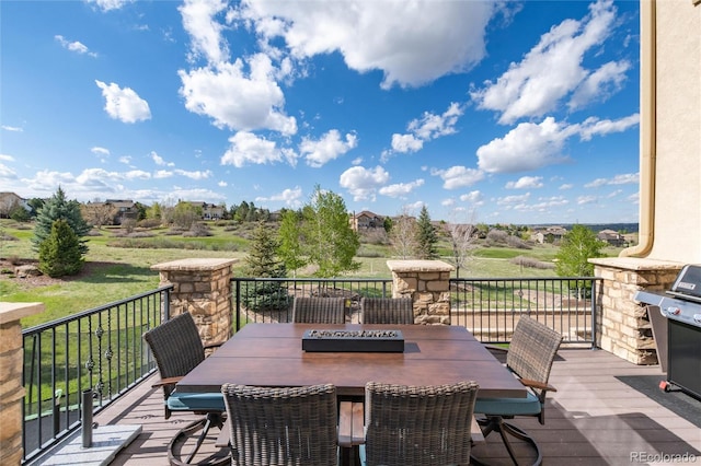 wooden terrace with outdoor dining area