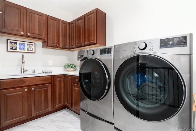 washroom with independent washer and dryer, cabinet space, and light marble finish floors